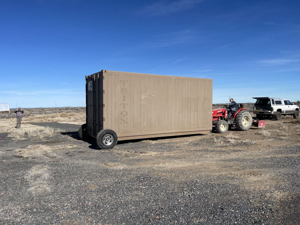 Shipping container with back wheel installed