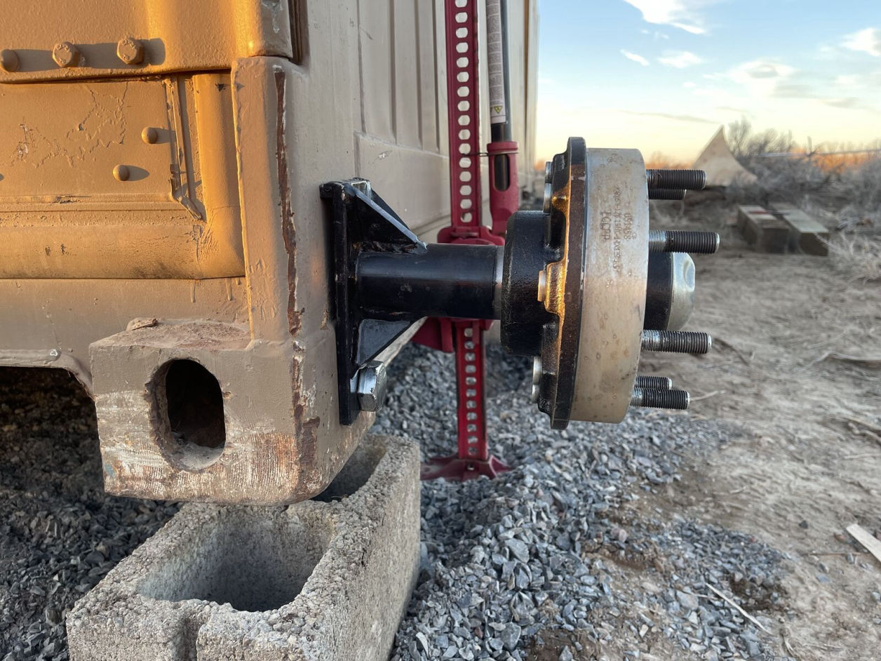 Installing wheel onto shipping container